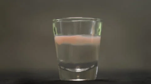 Perfumer pouring drops of oily scent into perfume in a glass. Process of Stock Footage 170649623
