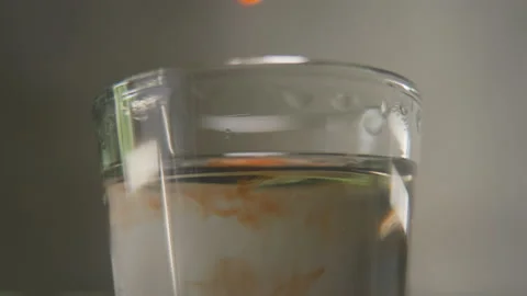 Perfumer pouring drops of oily scent into perfume in a glass. Process of Stockbeeldmateriaal 170761899