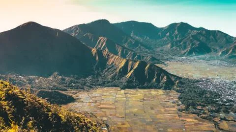 Pergasingan Hill view with multiple mountain peaks and rice field in Sembalun Stock Photos