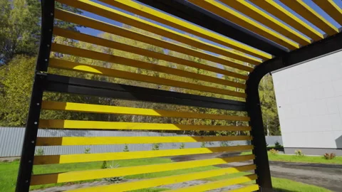 Pergola ceiling displays linear pattern against sunny sky Stock Footage 346073156