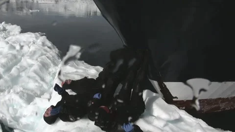 Perilous Position on Ice Floe in Front of Large Ship Stockbeeldmateriaal 321062624