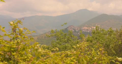Perinaldo Medieval Village Seen from Afar in Lush Italian Hills on a Cloudy Day Stock Footage 346470682