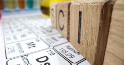 Periodic table of elements with flasks and liquid containing chemicals and word Stock Footage 259009481