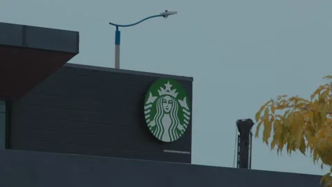 Perlis, Malaysia - October 9, 2022. Starbucks Coffee logo on a building. Stock Footage 218643818