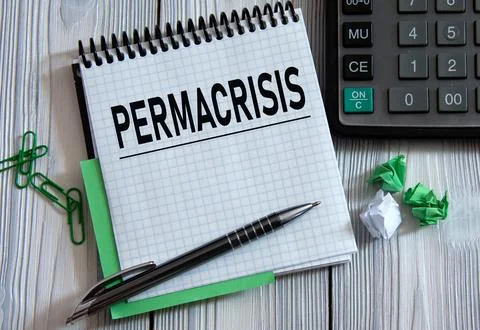 PERMACRISIS - word on a white notepad on the background of a calculator, pape Stock Photos