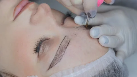 Permanent eyebrow tattooing in progress using hair-stroke technique Stock Footage 307511798