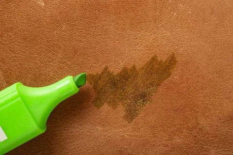 Permanent green marker scribbling on red brown leather,    close up Stock Photos