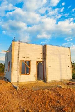 A permanent house made of lightweight brick is currently under construction. Stock Photos
