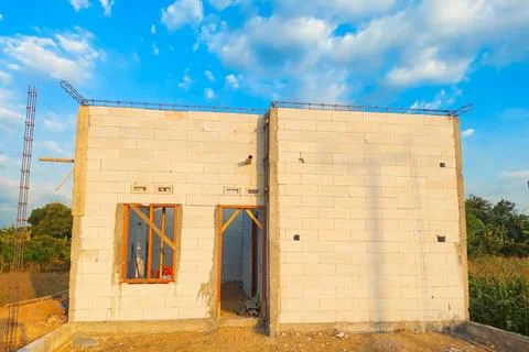 A permanent house made of lightweight brick is currently under construction. Stock Photos