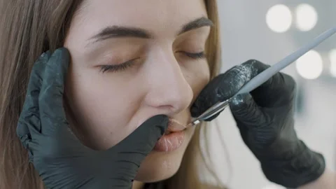Permanent makeup application in slow motion during a cosmetology session Stock Footage 319826566