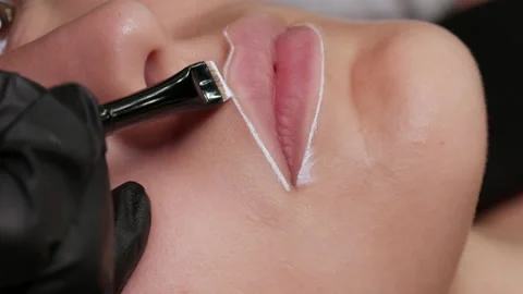 Permanent makeup artist microblading with a special brush with white paint Stock Footage 157352116