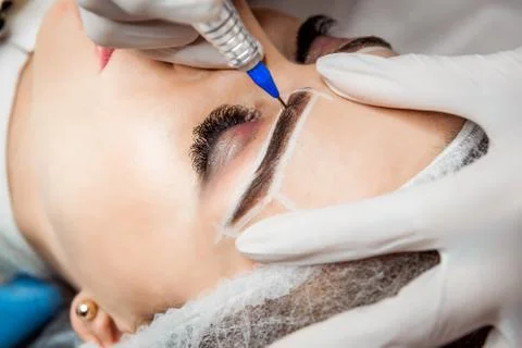 Permanent Makeup For Eyebrows. Closeup Of Beautiful Woman With Thick Brows In Foto stock