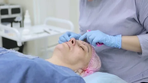 Permanent makeup. Permanent tattooing of eyebrows. Stock-Footage 80034124