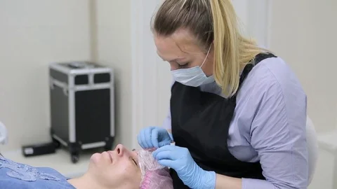 Permanent makeup. Permanent tattooing of eyebrows. Stock Footage 80088199