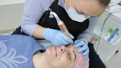 Permanent makeup. Permanent tattooing of eyebrows. Stock-Footage 80137155
