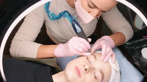 Permanent makeup. Permanent tattooing of eyebrows. Stockbeeldmateriaal 149007735