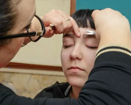 Permanent makeup. Permanent tattooing of eyebrows Stock Photos