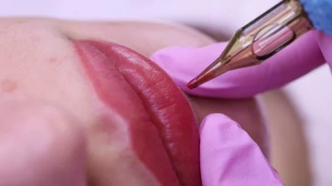 Permanent makeup of pink lips on a light background.  Tattoo of pink lips.  Pink Stock Footage 131433866