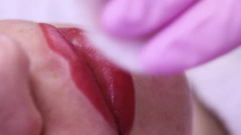 Permanent makeup of pink lips on a light background.  Tattoo of pink lips.  Pink Stock Footage 131433922