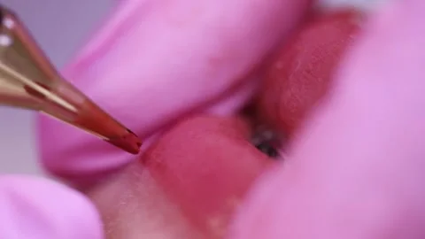 Permanent makeup of pink lips on a light background.  Tattoo of pink lips.  Pink Stock Footage 131434088