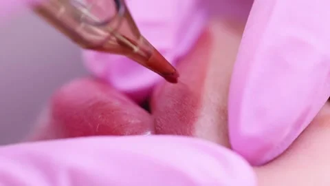 Permanent makeup of pink lips on a light background.  Tattoo of pink lips.  Pink Stock Footage 131434213