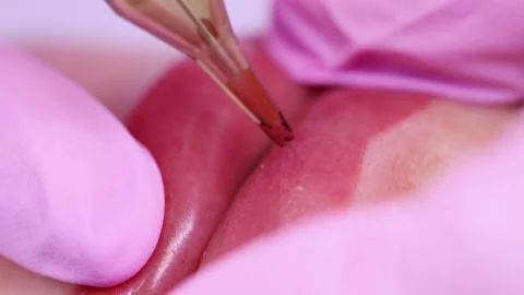 Permanent makeup of pink lips on a light background.  Tattoo of pink lips.  Pink Stock Footage 131434352