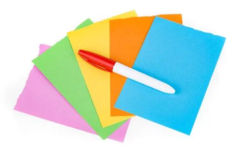 Permanent red marker on multicolored note pad papers isolated over white. Top Stock Photos