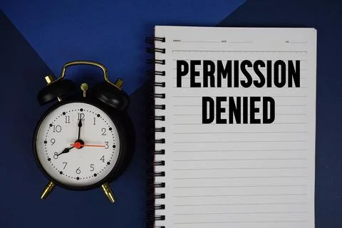 Permission Denied text written on notepad with alarm clock on blue background Stock Photos