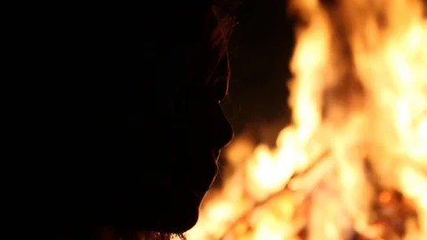 Peron's face outlined by glaring fire Stock Footage 122801629