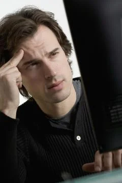 Perplexed man at computer Stock Photos
