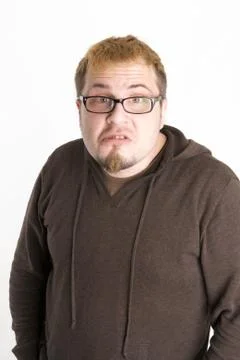 Perplexed Man with Glasses and Brown Sweatshirt Stock Photos