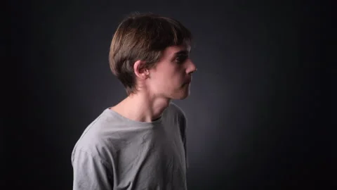 Perplexed Man spreading arms on black Background Stock Footage 257460269