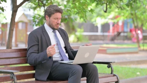 Perplexed Middle Aged Businessman Using Laptop Outdoor Stock-Footage 313584879