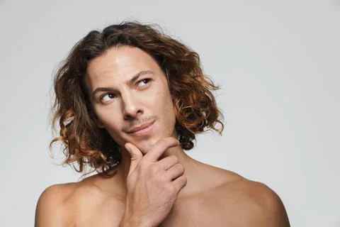 Perplexed shirtless guy thinking and looking upward Stock Photos
