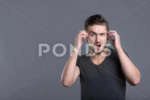 Perplexed young bearded man opening mouth Stock Photos