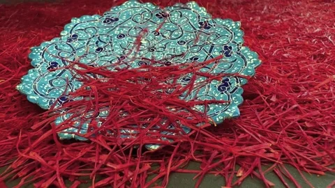 Persian saffron falling in a turquoise plate Stock Footage 171234253