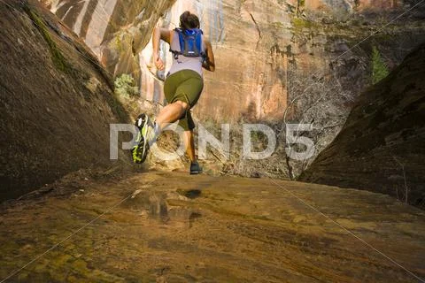 Persian woman running in a remote area Stock Photos