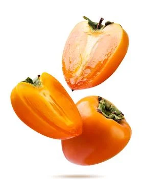 Persimmon and two halves fly close-up on a white background. Isolated Stock Photos
