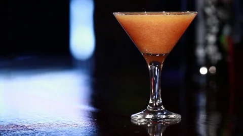 A persimmon cocktail is on the bar. Stock Footage 80309326