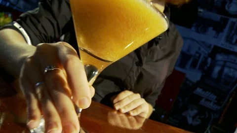 Persimmon coctail. The bartender moves the cocktail to the counter. Stock Footage 80309545