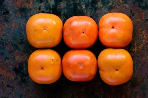 Persimmon fruit background. Stock Photos