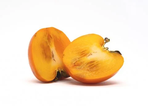 Persimmon fruit in a cut on a white background. Stock Photos