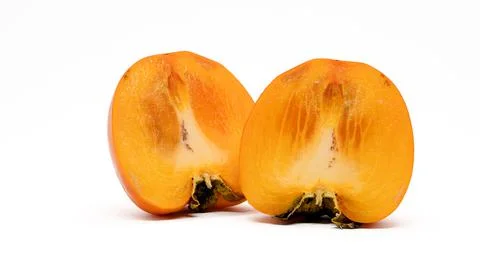 Persimmon fruit in a cut on a white background. Stock Photos