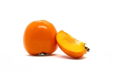 Persimmon fruit with a slice on a white background. Stock Photos