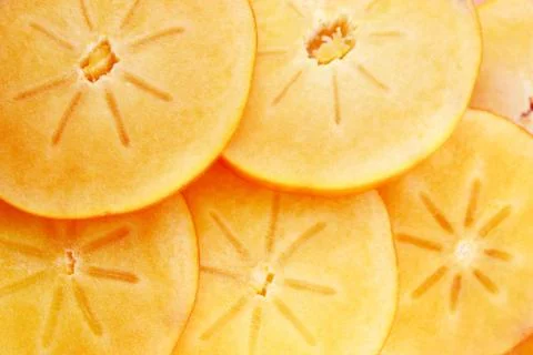Persimmon fruit slices Stock Photos
