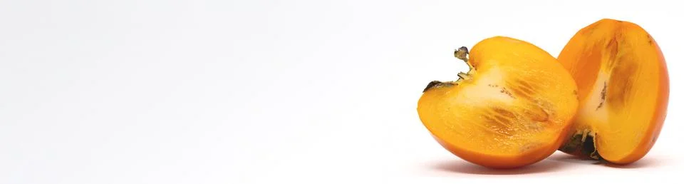 Persimmon fruit from two halves in a section. Stock Photos