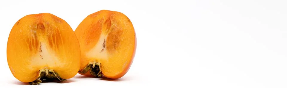 Persimmon fruit from two halves in a section. Stock Photos