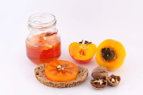 Persimmon jam her bread and walnuts Stock Photos
