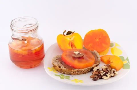 Persimmon jam her bread and walnuts Stock Photos