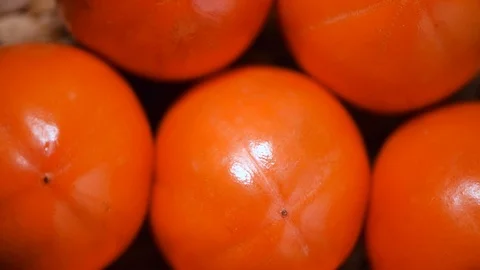Persimmon on rotating background. Top view. Vegan and raw food concept. Orange Stock Footage 125419129